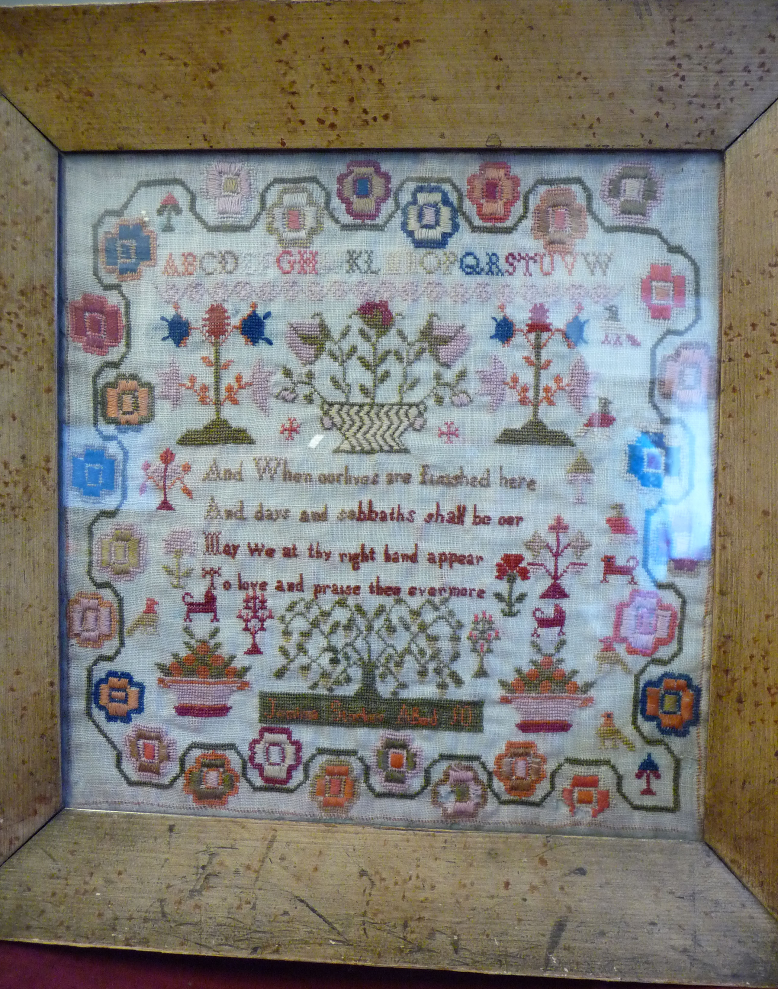 An early 19thC sampler, featuring four lines of text, the alphabet and extensive border ornament, - Image 2 of 10