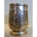 A late Victorian silver Christening mug of baluster form with a hollow loop handle,