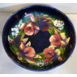 A Moorcroft pottery fruit bowl, decorated in a version of the Orchid design,