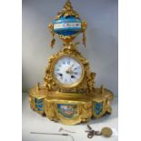 A late 19thC French gilt metal cased mantel clock with painted and gilded porcelain panels,
