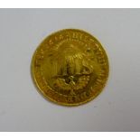 A gold medallion/coin inscribed IHS & dated 1616