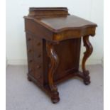A late Victorian burr walnut veneered Davenport with a sloping, hinged top,