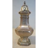 A silver caster of square pedestal vase design with incurved corners, a pierced,