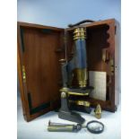 A late 19th/early 20thC lacquered brass and enamelled monocular microscope,