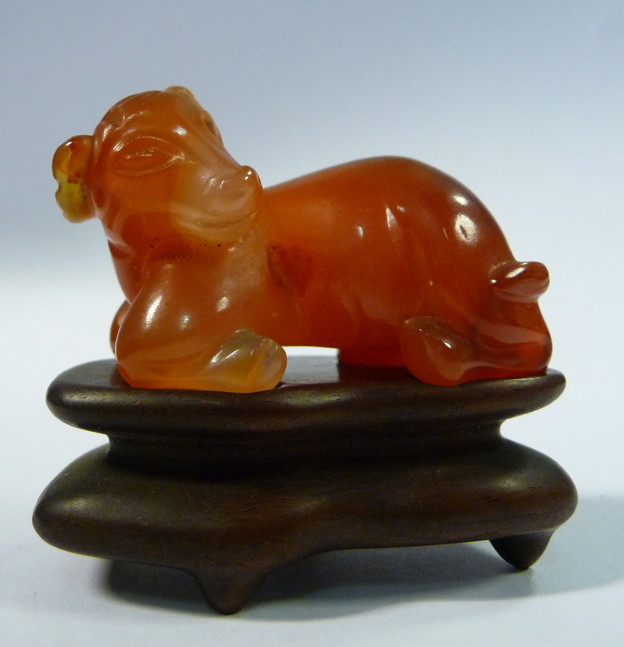 An early 20thC carved orange jadeite model,