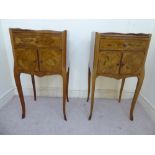 A pair of mid 20thC French kingwood veneered and floral marquetry bedside cabinets,