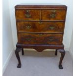A George III walnut veneered chest on a later stand,