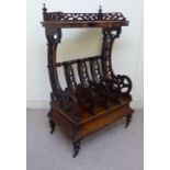 A late Victorian framed and fretworked walnut Canterbury with a galleried,
