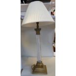 A mid 20thC brass table lamp with a cast Corinthian capital, over a clear wrythen moulded,