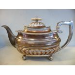 A Georgian style silver teapot of oval, ogee form with egg-and-dart, shell and demi-reeded ornament,