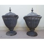 A pair of 19thC cast lead terrace urns of fluted pedestal vase design with flank masks,