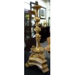 A modern gilt metal table lamp of urn design, decorated with masks and mythical winged beasts,