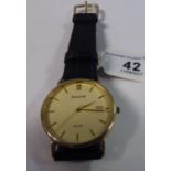 An Accurist 9ct gold cased wristwatch, faced by a baton dial with a date aperture,