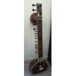 A 20thC sitar with four principal strings 50''L overall CA