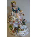A 20thC German porcelain figure, a seated woman, a dog at her side and a sheep by her feet,