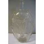 An early 19thC clear glass bottle of lozenge form, decorated with simple, applied flora,