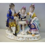 A 20thC German porcelain group, a man with a lute, serenading two young women,