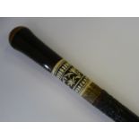 A 1930s swordstick with a lightly carved, ebonised shaft, a brass ferrule and an inked,