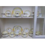 A Shelley china Regent shape part tea set, decorated in Art Deco taste in yellow,