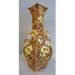 A Zsolnay Pecs china twin handled bottle vase of square outline with a narrow neck and flared,