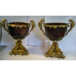 A pair of 20thC gilt metal mounted, facet cut cranberry coloured glass wine cups,