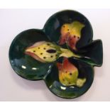 A Moorcroft pottery leaf dish, decorated in an orchid inspired design,