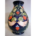 A modern Moorcroft pottery vase of ovoid form, decorated in colours and tubeline with strawberries,