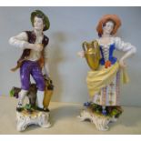 A pair of 20thC German porcelain figures, a standing woman,