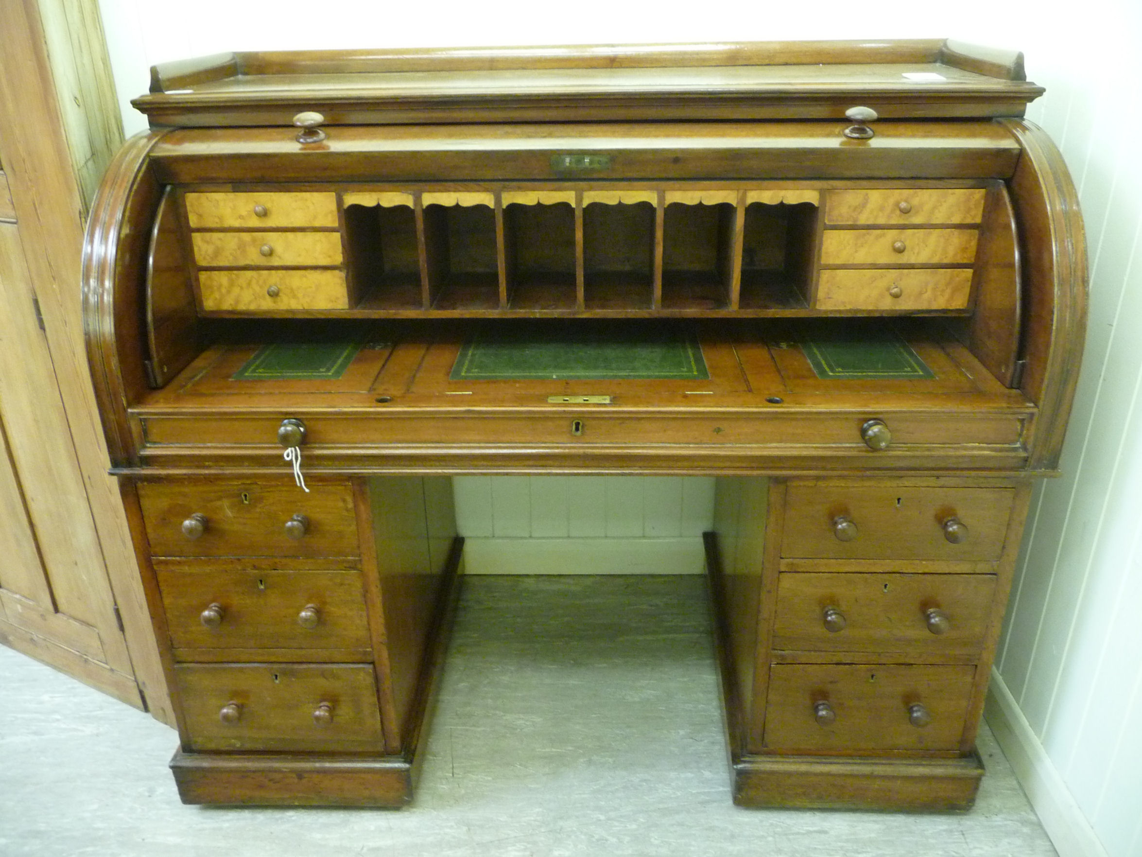 A late Victorian mahogany cylinder front desk,