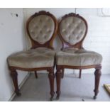 A pair of late Victorian walnut showwood framed balloon back chairs,