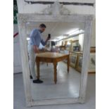 A late 20thC mirror, the rectangular plate set in a white painted, C-scroll,