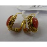 A pair of yellow metal earrings,
