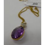 A 15ct gold chain with a diamond and amethyst pendant 11