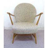 An Ercol pale coloured beech and darker elm, high hoop and spindled back,