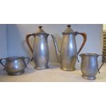 An English pewter Tudric spot-hammered, four piece coffee set of baluster form,
