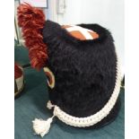 A reproduction of Napoleon's Imperial guard fur cap with a scarlet feather plume