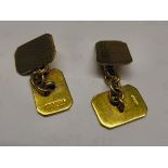A pair of 9ct gold cufflinks with engraved ornament