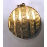 A 9ct gold disc pendant with engine turned ornament