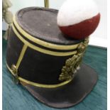 A reproduction of a 64th Shako with a red and white pompom