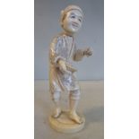 An early 20thC Japanese carved and stained ivory standing artisan figure, on a circular plinth 5.