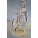 An early 20thC Japanese carved ivory artisan group, two women, one standing, the other seated,