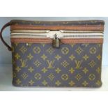 An early/mid 20thC Louis Vuitton reinforced stitched brown hide, vanity case with original padlock,
