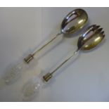 A pair of Edwardian silver salad servers with plain bowls,
