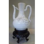 A late 19thC Chinese ivory glazed porcelain Dehva wine ewer of bulbous form,