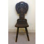A late 19thC hall chair, the back carved with acorns and foliage,