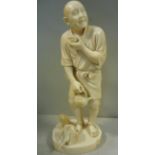 A 19thC Japanese carved ivory standing figure, an itinerant holding a tea bowl and kettle,