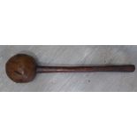 A mid 19thC Pacific Island gnarled fruitwood club with a carved handgrip 17''L overall