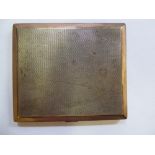 A bi-coloured silver folding cigarette case with chamfered sides and engine turned decoration,