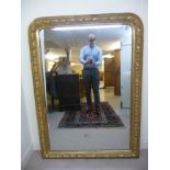 A mid/late 19thC mirror, the arched plate set in a moulded gilt frame with bead,