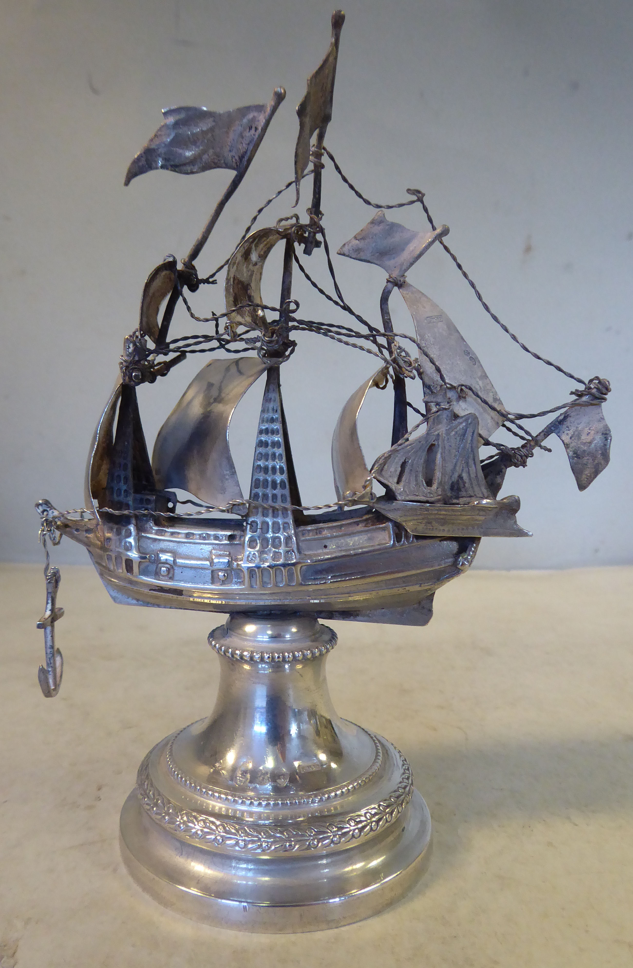 An early 20thC silver coloured metal model, a triple masted galleon with sails and rigging,